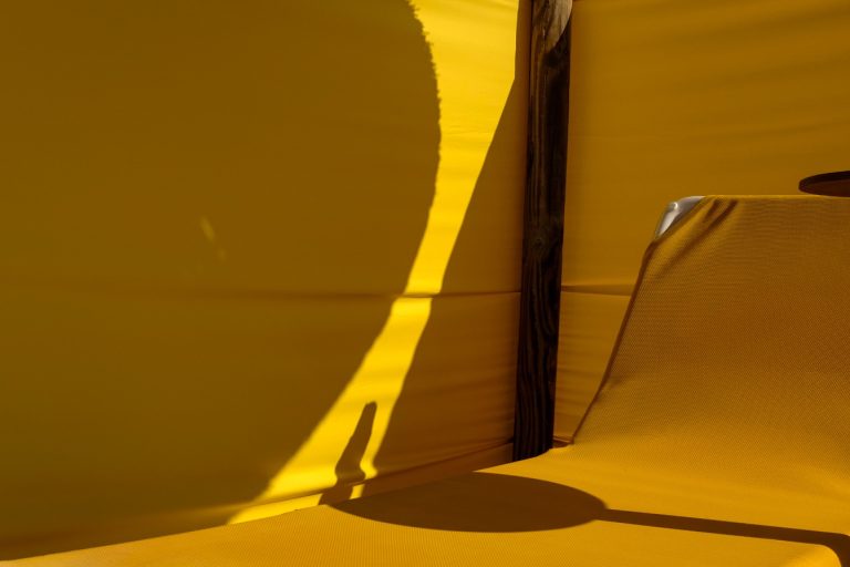 Street photo in Praia dos Tres Irmaos, Portugal by David Rathbone