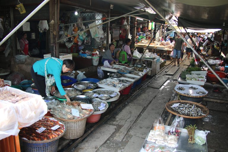 Street photo in Mae Klong, Thailand by Nik TAN
