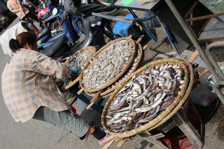 Street photo in Mae Klong, Thailand by Nik TAN