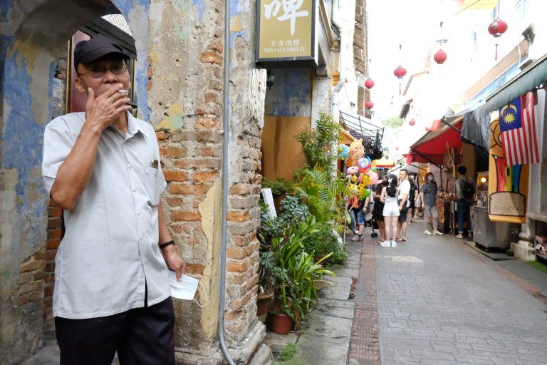 Street photo in Ipoh, Malaysia by Nik TAN