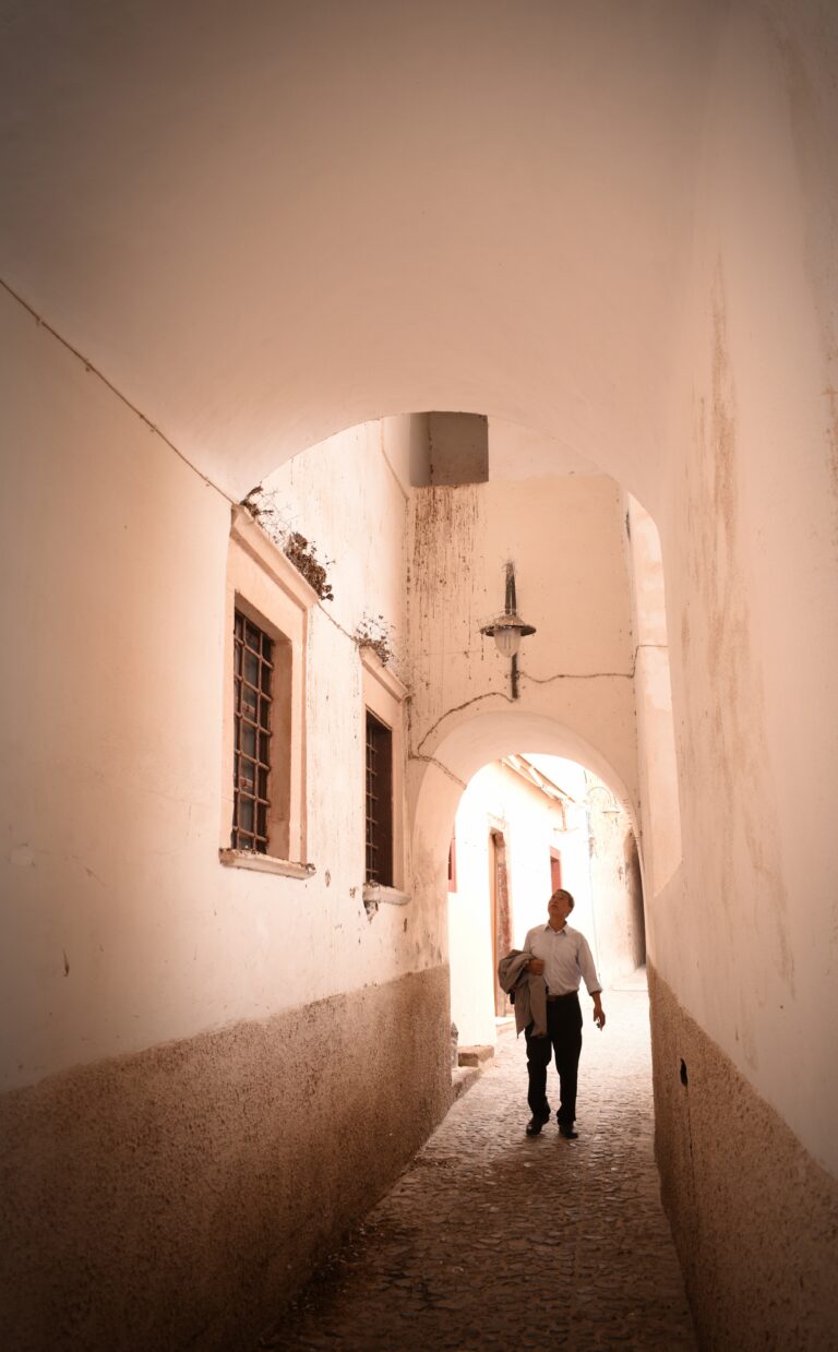 Street photo in Fira, Greece by Rodrigo Marcotich